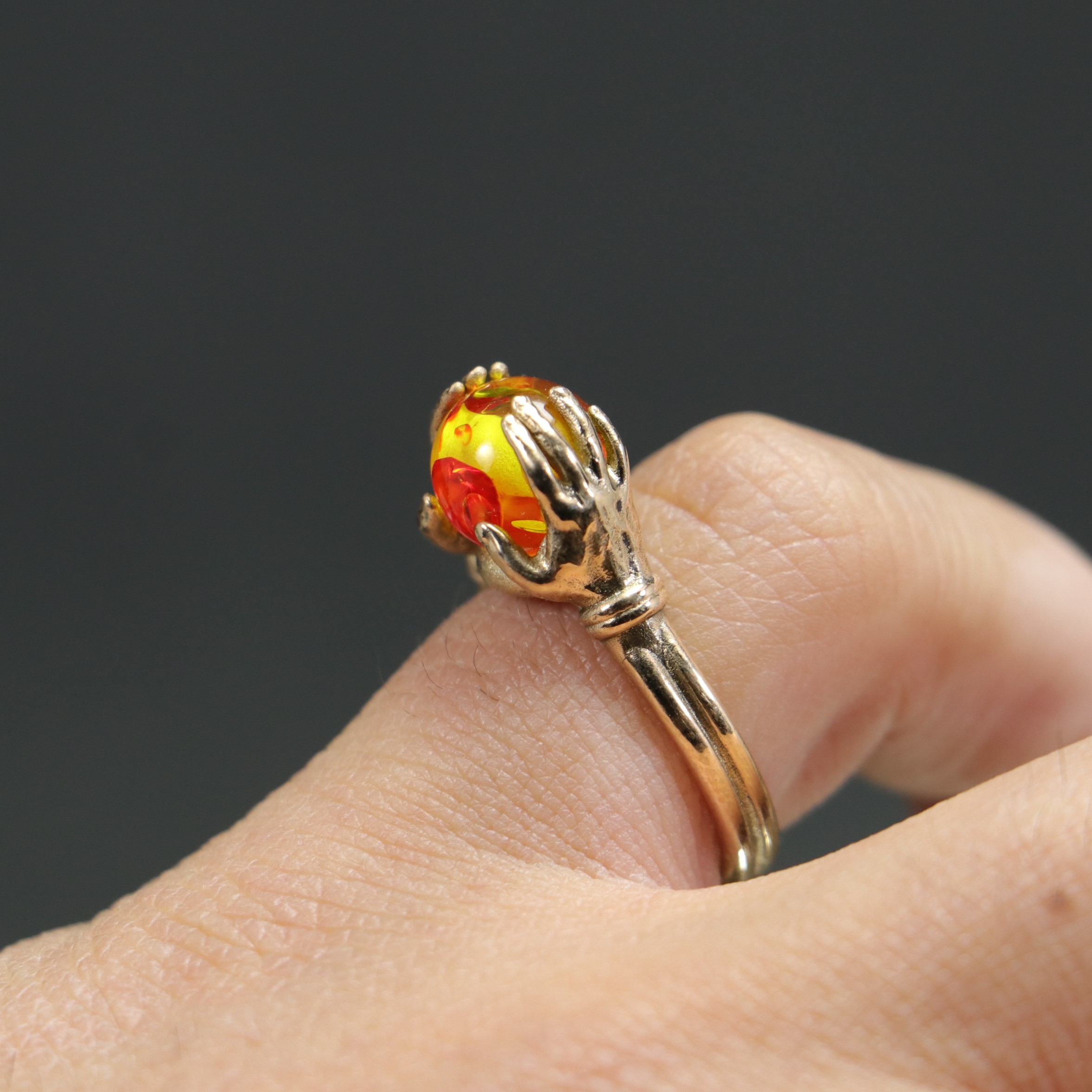 Amber Ring Between Hands