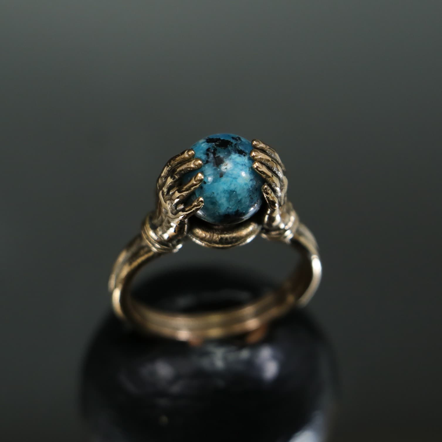 Turquoise Stone Ring Between Hands